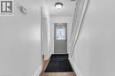 Entryway featuring a decorative transom door, wood-finish flooring, and white painted walls - 168 Britannia Avenue, Hamilton, ON  - Indoor Photo Showing Other Room 