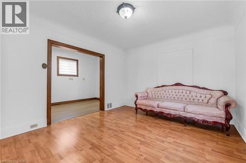Spacious room featuring wood-finish flooring, white walls, and a recessed window frame - 168 Britannia Avenue, Hamilton, ON - Indoor Photo Showing Bedroom