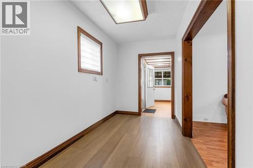 Interior hallway featuring wood-finish flooring, white walls, and dark wood trim - 168 Britannia Avenue, Hamilton, ON - Indoor Photo Showing Other Room