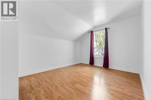 Bright room featuring wood-finish flooring, white walls, and a window with natural light - 168 Britannia Avenue, Hamilton, ON - Indoor Photo Showing Other Room