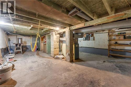 Unfinished basement with concrete flooring, exposed joists, and visible structural beams - 168 Britannia Avenue, Hamilton, ON - Indoor Photo Showing Basement