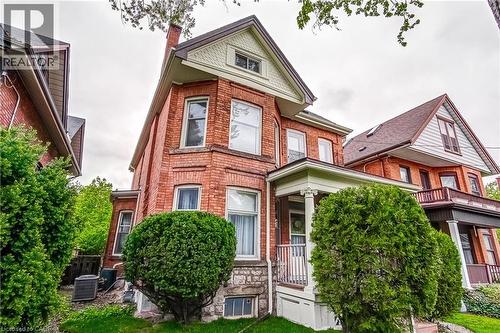 Brick residence featuring a stone foundation and a prominent bay window - 18 Fairleigh Crescent, Hamilton, ON - Outdoor