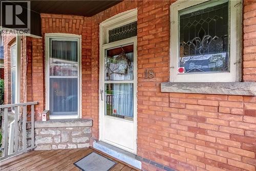 Brick exterior featuring stone accents and a wood porch - 18 Fairleigh Crescent, Hamilton, ON - Outdoor With Exterior