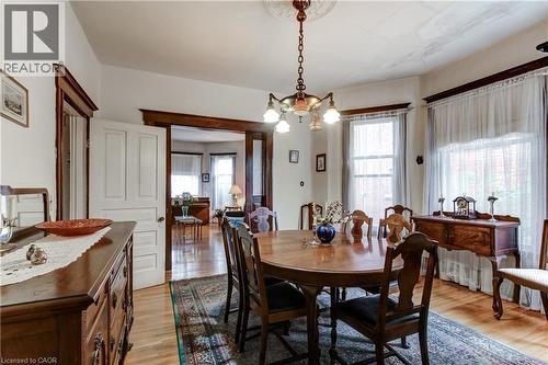 Hardwood flooring extends throughout this room, featuring ornate trim work and architectural doorways - 18 Fairleigh Crescent, Hamilton, ON - Indoor Photo Showing Dining Room