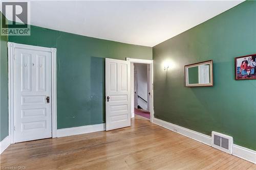 Room with wood-finish flooring and green walls - 18 Fairleigh Crescent, Hamilton, ON - Indoor