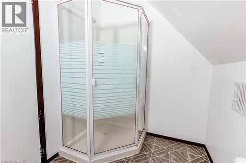 Corner shower enclosure featuring clear and frosted glass panels, an overhead shower fixture, and a white shower pan - 18 Fairleigh Crescent, Hamilton, ON - Indoor Photo Showing Bathroom