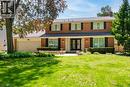 Brick-front residence featuring a double-door entry, a two-car garage, and established landscaping - 25 Braemar Place, Hamilton, ON  - Outdoor With Facade 