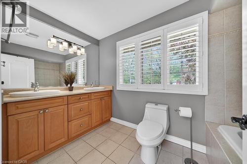 Dual vanity with undermount sinks and light wood-finish cabinetry - 25 Braemar Place, Hamilton, ON - Indoor Photo Showing Bathroom
