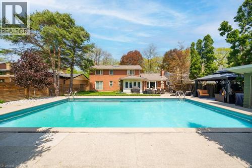 Expansive outdoor swimming pool with concrete surround - 25 Braemar Place, Hamilton, ON - Outdoor With In Ground Pool With Backyard