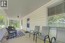 Covered front porch with light-colored siding, a white front door, and a white window frame with blinds - 1463 Kossuth Road, Cambridge, ON  - Outdoor With Deck Patio Veranda With Exterior 
