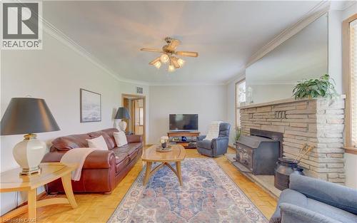 Living room featuring wood-finish flooring and crown molding - 1463 Kossuth Road, Cambridge, ON - Indoor Photo Showing Living Room With Fireplace