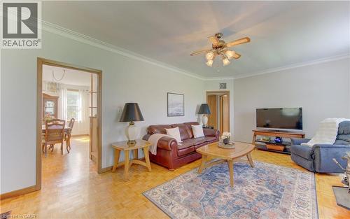 Living room featuring wood-finish flooring, crown molding, and a ceiling fan with light fixture - 1463 Kossuth Road, Cambridge, ON - Indoor Photo Showing Living Room