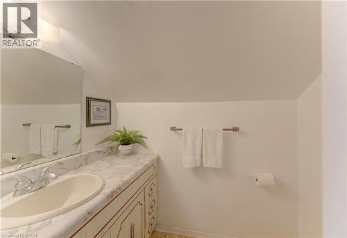 Bathroom vanity featuring a built-in sink, decorative base cabinetry, and a spacious countertop - 1463 Kossuth Road, Cambridge, ON - Indoor Photo Showing Bathroom