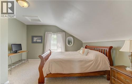 Carpeted room featuring a ceiling-mounted light fixture, painted walls, and an attic access panel - 1463 Kossuth Road, Cambridge, ON - Indoor Photo Showing Bedroom