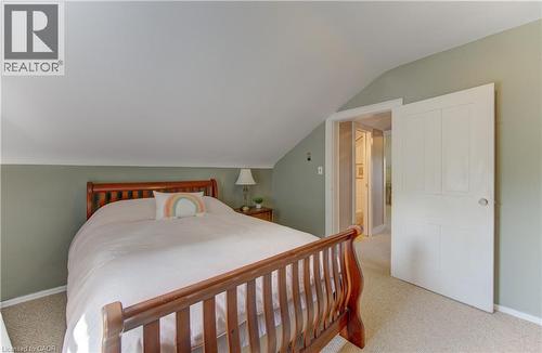 Carpeted bedroom featuring a sloped ceiling and a paneled white door - 1463 Kossuth Road, Cambridge, ON - Indoor Photo Showing Bedroom