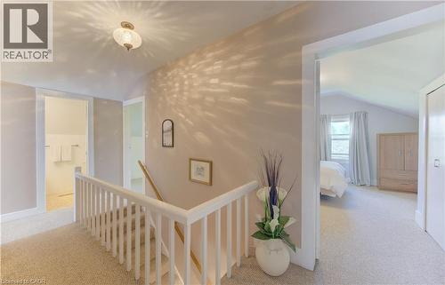 Carpeted hallway featuring a white spindle railing and a flush mount ceiling light - 1463 Kossuth Road, Cambridge, ON - Indoor Photo Showing Other Room