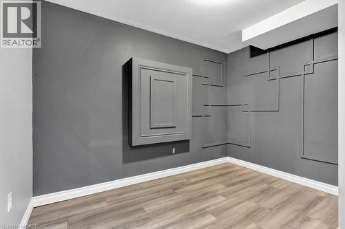 Room featuring modern wall paneling and wood-finish flooring - 49 Small Court, Cambridge, ON - Indoor Photo Showing Other Room