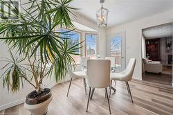 Dining area featuring light wood-finish flooring and a bay window - 