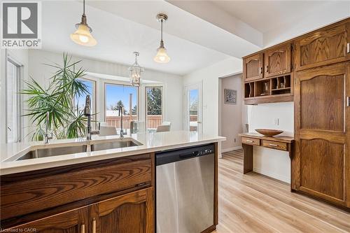 Kitchen featuring a large central island with double undermount sinks, stainless steel dishwasher, and quartz countertop - 488 Heather Hill Place, Waterloo, ON - Indoor Photo Showing Kitchen With Double Sink