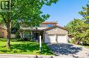 Stone-front residence featuring a two-car garage, mature front yard landscaping, paved driveway, and a covered entry - 488 Heather Hill Place, Waterloo, ON  - Outdoor 