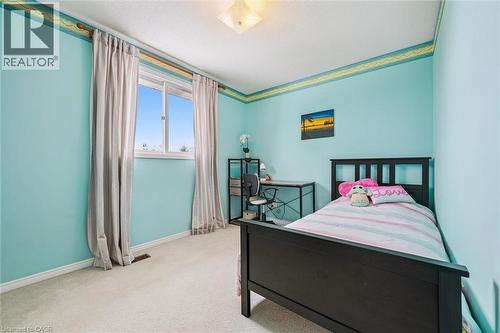 Spacious interior with neutral carpeting and light blue walls - 488 Heather Hill Place, Waterloo, ON - Indoor Photo Showing Bedroom