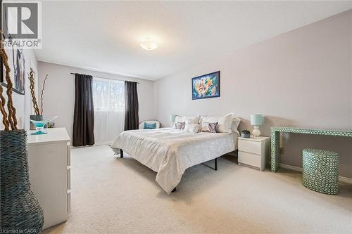 Spacious bedroom featuring plush carpeting and neutral wall tones - 488 Heather Hill Place, Waterloo, ON - Indoor Photo Showing Bedroom
