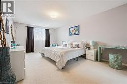 Spacious bedroom featuring plush carpeting and neutral wall tones - 