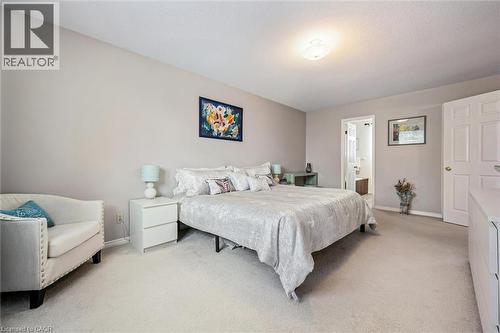 Carpeted bedroom featuring light neutral wall paint and a flush-mount ceiling light - 488 Heather Hill Place, Waterloo, ON - Indoor Photo Showing Bedroom