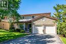 Two-story residence featuring a stone-clad garage facade, an asphalt driveway, and a covered front entry with columns - 488 Heather Hill Place, Waterloo, ON  - Outdoor 