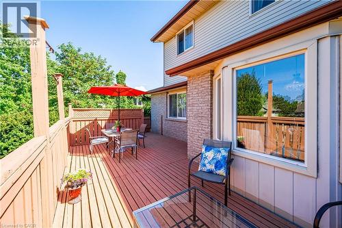 Expansive wood-finish deck with privacy lattice, surrounded by lush trees - 488 Heather Hill Place, Waterloo, ON - Outdoor With Deck Patio Veranda With Exterior