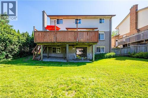 Rear exterior with a spacious wooden deck featuring wood railings and stairs - 488 Heather Hill Place, Waterloo, ON - Outdoor With Deck Patio Veranda