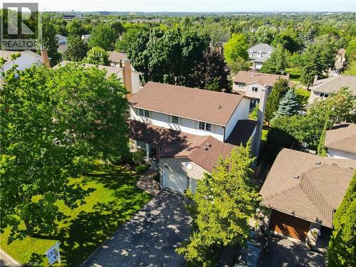 Residential property featuring a two-story structure with a brown shingle roof, attached garage, and a paved driveway - 488 Heather Hill Place, Waterloo, ON - Outdoor