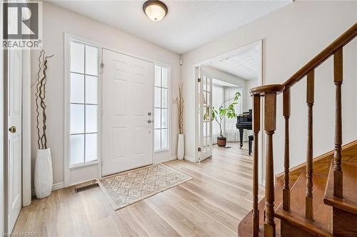 Entryway featuring a solid panel door with frosted sidelights, wood-finish flooring, and a flush mount ceiling light - 488 Heather Hill Place, Waterloo, ON - Indoor Photo Showing Other Room