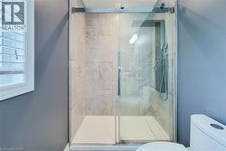 Walk-in shower with clear glass enclosure and sliding door - 