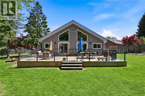 Expansive backyard featuring a large wood-finish deck with glass panel railing - 24 Glenwood Crescent, Hamilton, ON - Outdoor