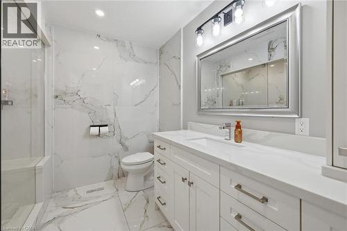 Contemporary bathroom featuring extensive marble-look tile, a frameless glass shower enclosure, and a modern vanity with a white countertop - 24 Glenwood Crescent, Hamilton, ON - Indoor Photo Showing Bathroom
