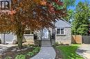 Stone facade residence featuring a front entry concrete walkway, mature landscaping, and a fenced side yard - 24 Glenwood Crescent, Hamilton, ON  - Outdoor 
