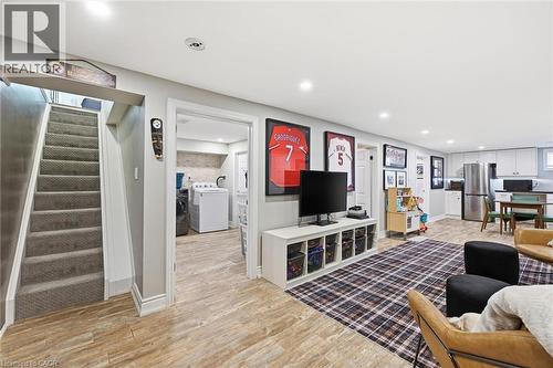 Spacious finished lower level featuring wood-finish flooring, recessed lighting, and a neutral color palette - 24 Glenwood Crescent, Hamilton, ON - Indoor