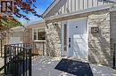 Stone veneer facade with a white paneled entry door, sidelight, and wrought iron railing - 24 Glenwood Crescent, Hamilton, ON  - Outdoor With Exterior 