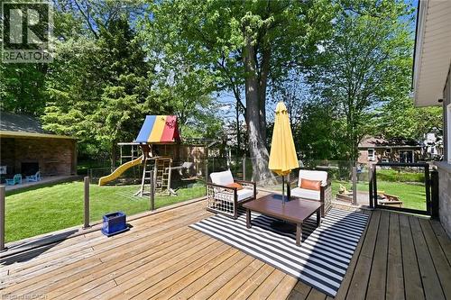 Spacious rear deck featuring wood-finish flooring and glass panel railing - 24 Glenwood Crescent, Hamilton, ON - Outdoor With Deck Patio Veranda