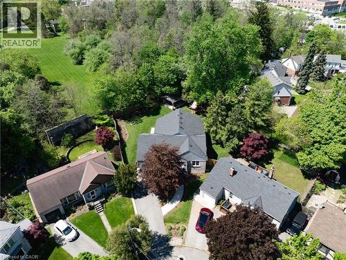 Expansive property featuring a large backyard with manicured lawn, mature trees, and a stone retaining wall - 24 Glenwood Crescent, Hamilton, ON - Outdoor