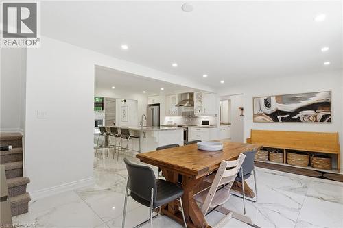 Open-concept dining area featuring large format marble-look tile flooring and recessed lighting - 24 Glenwood Crescent, Hamilton, ON - Indoor Photo Showing Dining Room