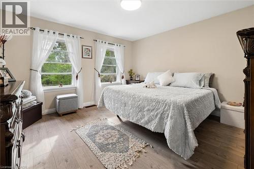 Bedroom featuring two double-hung windows, light-toned walls, and wood-finish flooring - 786 S Stirling Avenue S, Kitchener, ON - Indoor Photo Showing Bedroom
