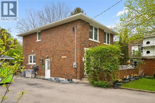 Brick exterior with multiple windows and white trim - 786 S Stirling Avenue S, Kitchener, ON - Outdoor With Exterior
