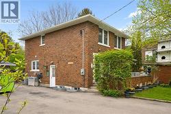 Brick exterior with multiple windows and white trim - 