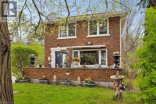 Brick exterior with white trim windows and a dark blue entry door - 786 S Stirling Avenue S, Kitchener, ON - Outdoor