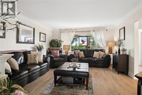 Spacious living area featuring wood-finish flooring, crown molding, and large window with abundant natural light - 786 S Stirling Avenue S, Kitchener, ON - Indoor Photo Showing Living Room