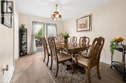 Dining area featuring light wood-finish flooring and neutral wall tones - 