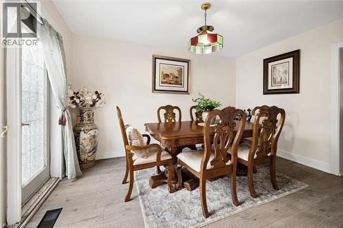 Dining area with light-toned wood-finish flooring, a glass-paned door, and white baseboards - 786 S Stirling Avenue S, Kitchener, ON - Indoor Photo Showing Dining Room