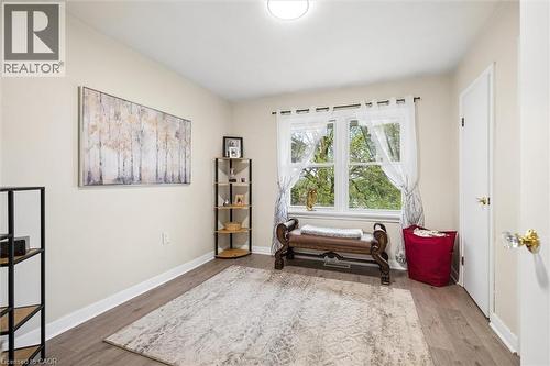 Bright room with wood-finish flooring, a large window, white trim, and light wall paint - 786 S Stirling Avenue S, Kitchener, ON - Indoor